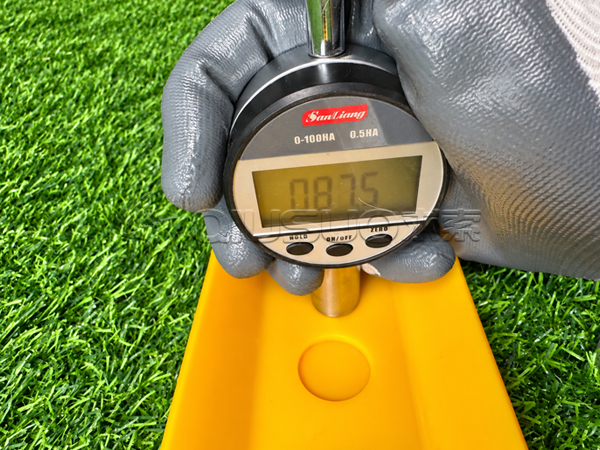 A worker is measuring the Shore A hardness of a polyurethane rail protection strip.
