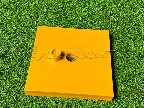 A polyurethane wear liner panel showing the mounting hole and removable polyurethane plug.