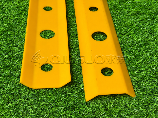 Two yellow polyurethane rail protection strips with installation holes - detailed view.