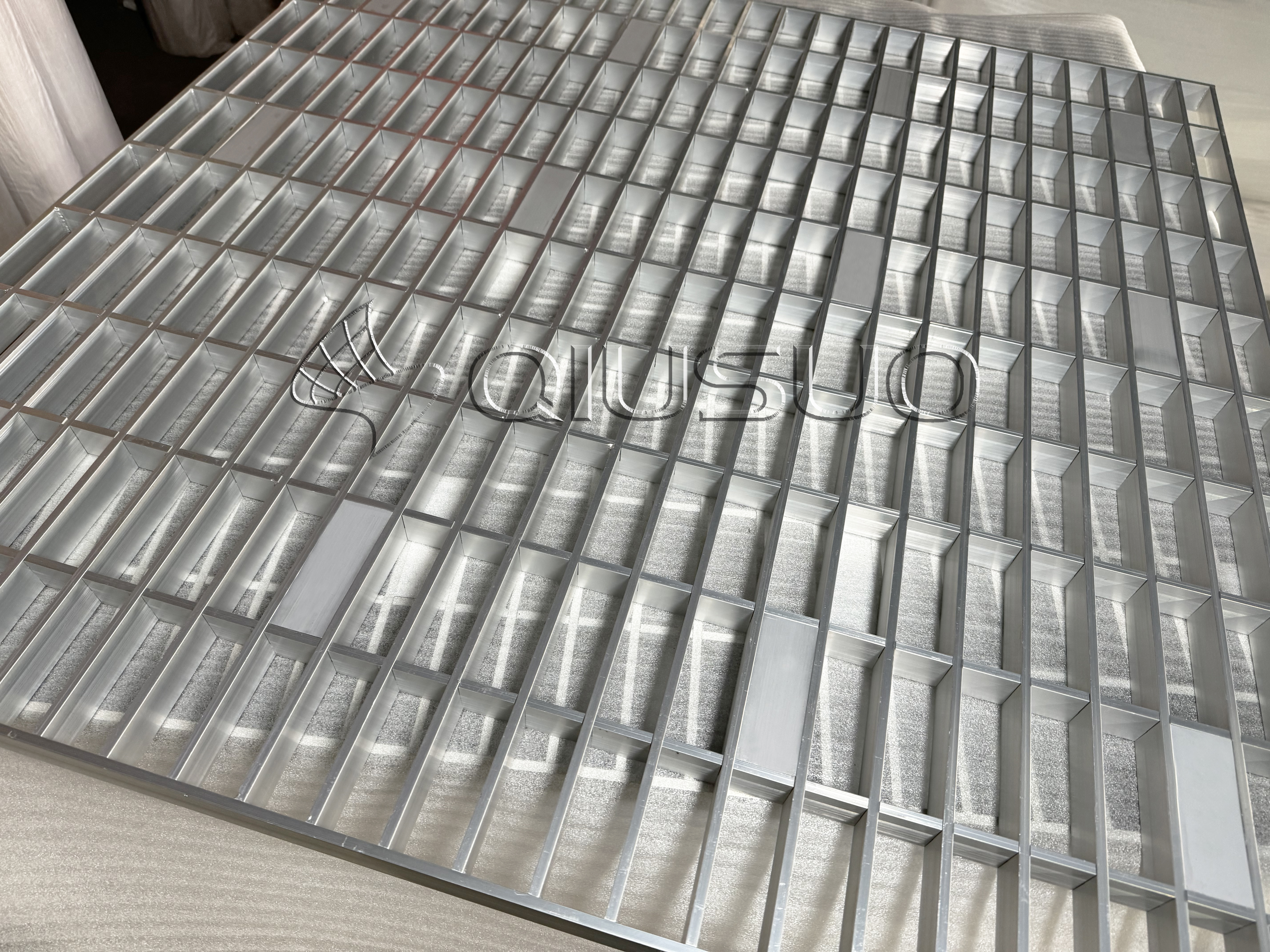 This is a photo of using drawings to check aluminum-grating specifications.