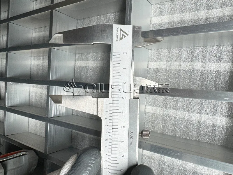 Measure the aperture size of the aluminum bar grating using a caliper.