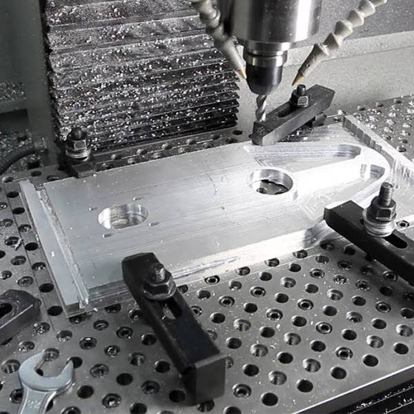 CNC drilling machine is drilling a steel plate.