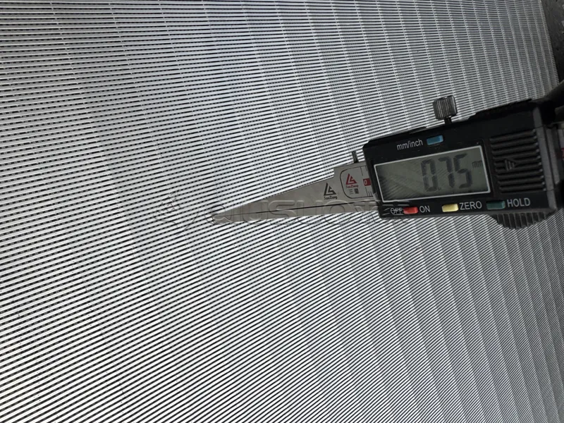 A worker is measuring the slots of the flat wedge wire screen panels.