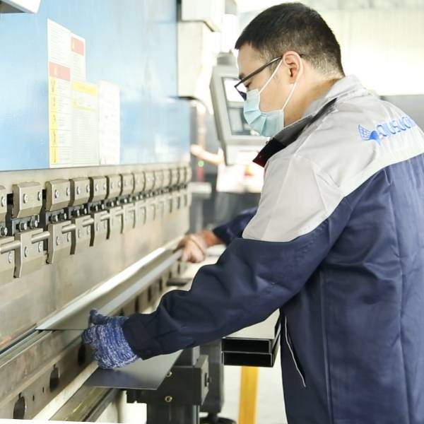 The CNC bending machine is bending the metal plate.