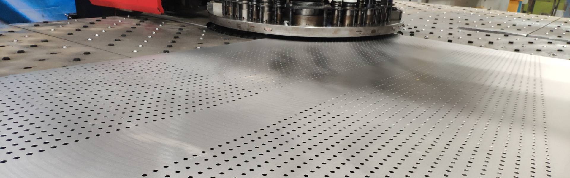 A machine is producing perforated mesh sheets.
