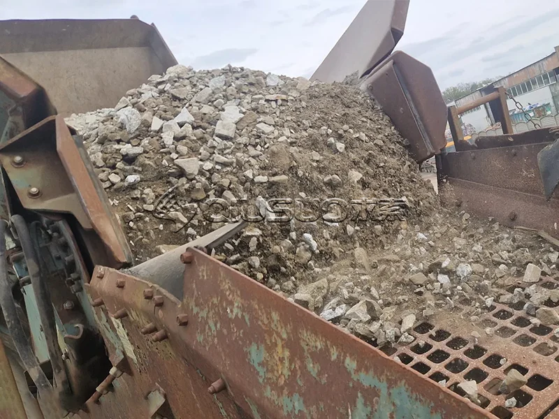 Side view of screening equipment processing construction waste