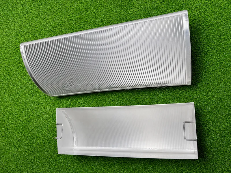 Two finished sieve bend screens are placed on the green mat.
